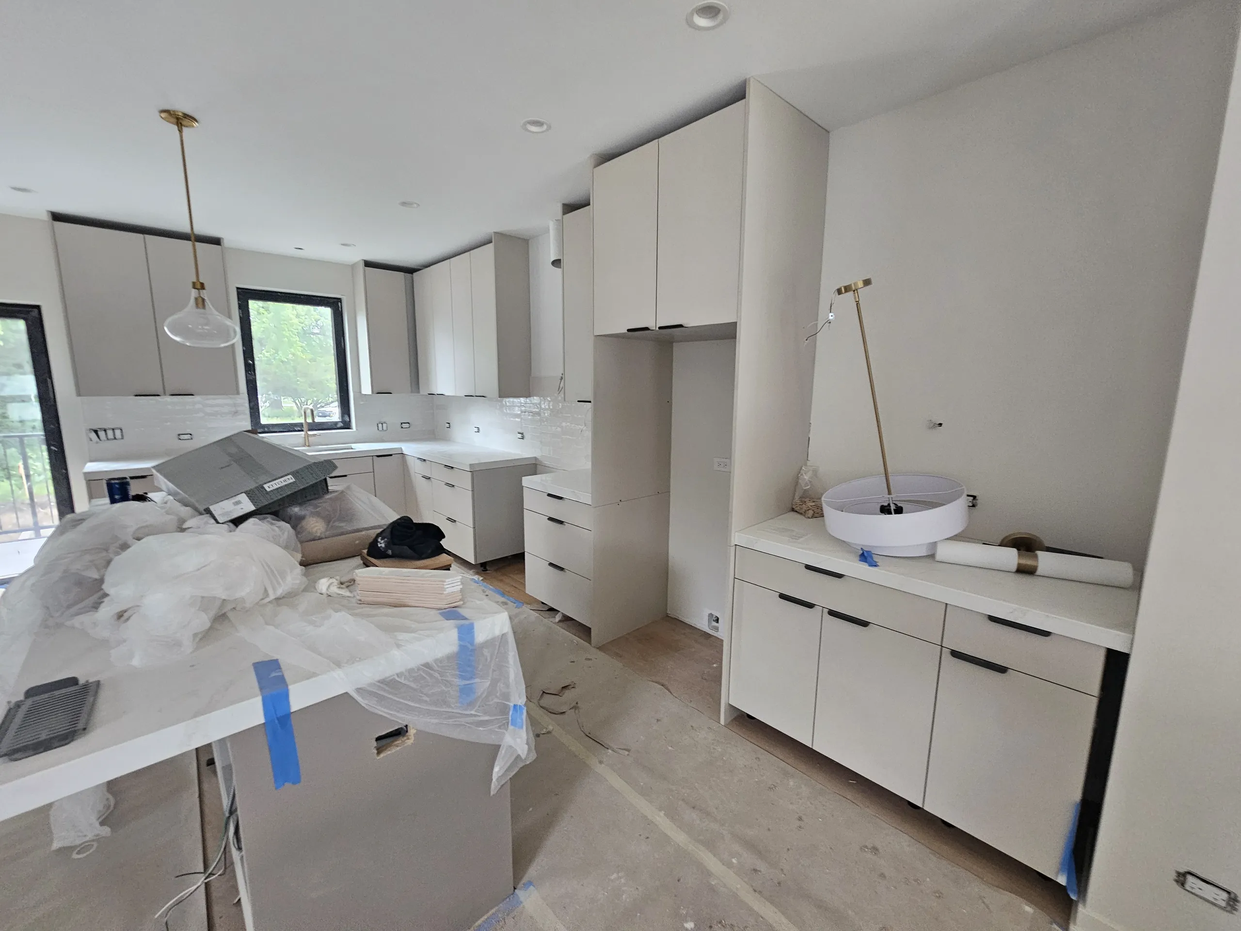 Modern kitchen renovation featuring cabinets and countertop installation with a clean, organized layout