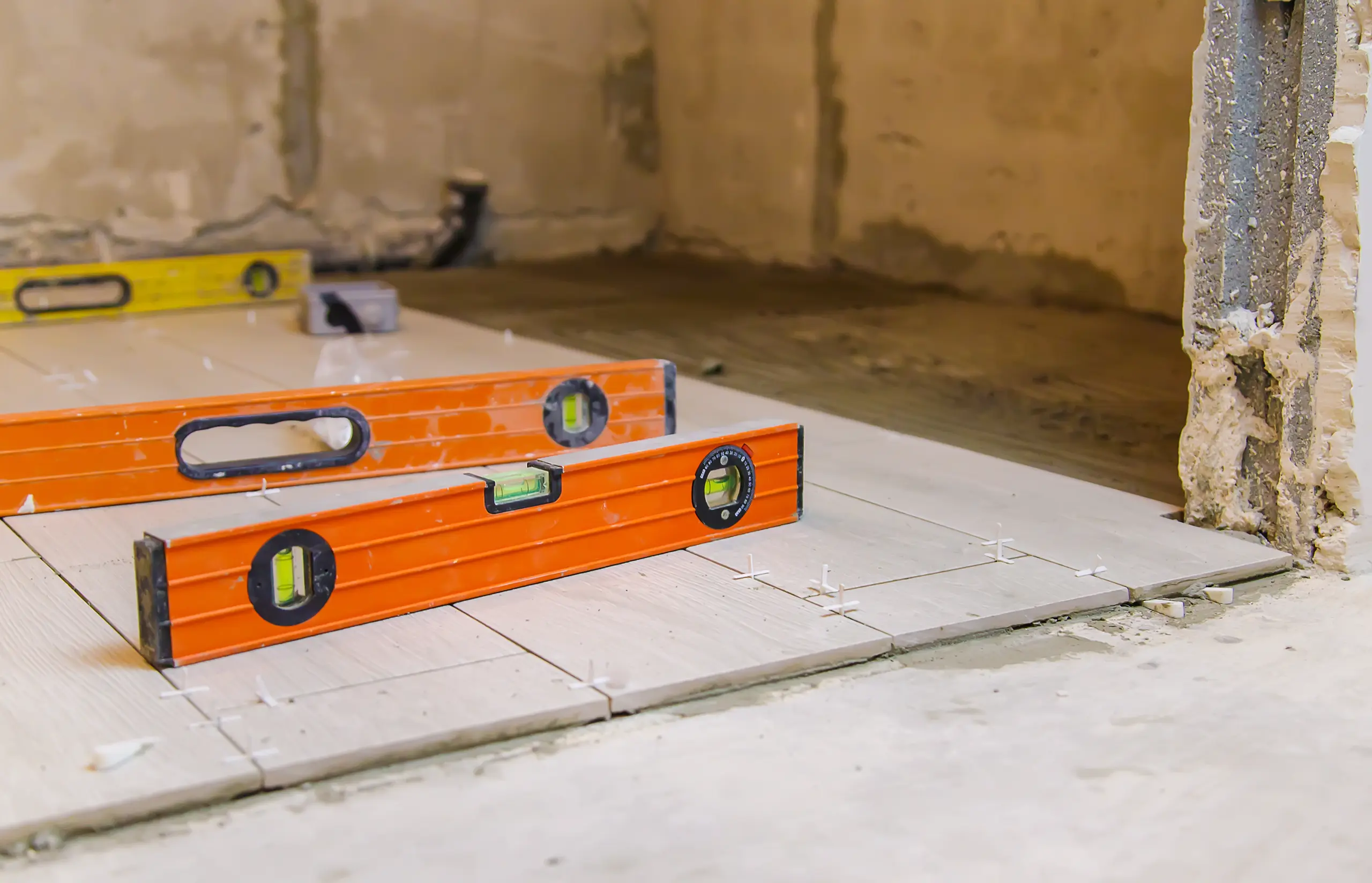 Leveling tool on newly laid tiles during a tile installation project