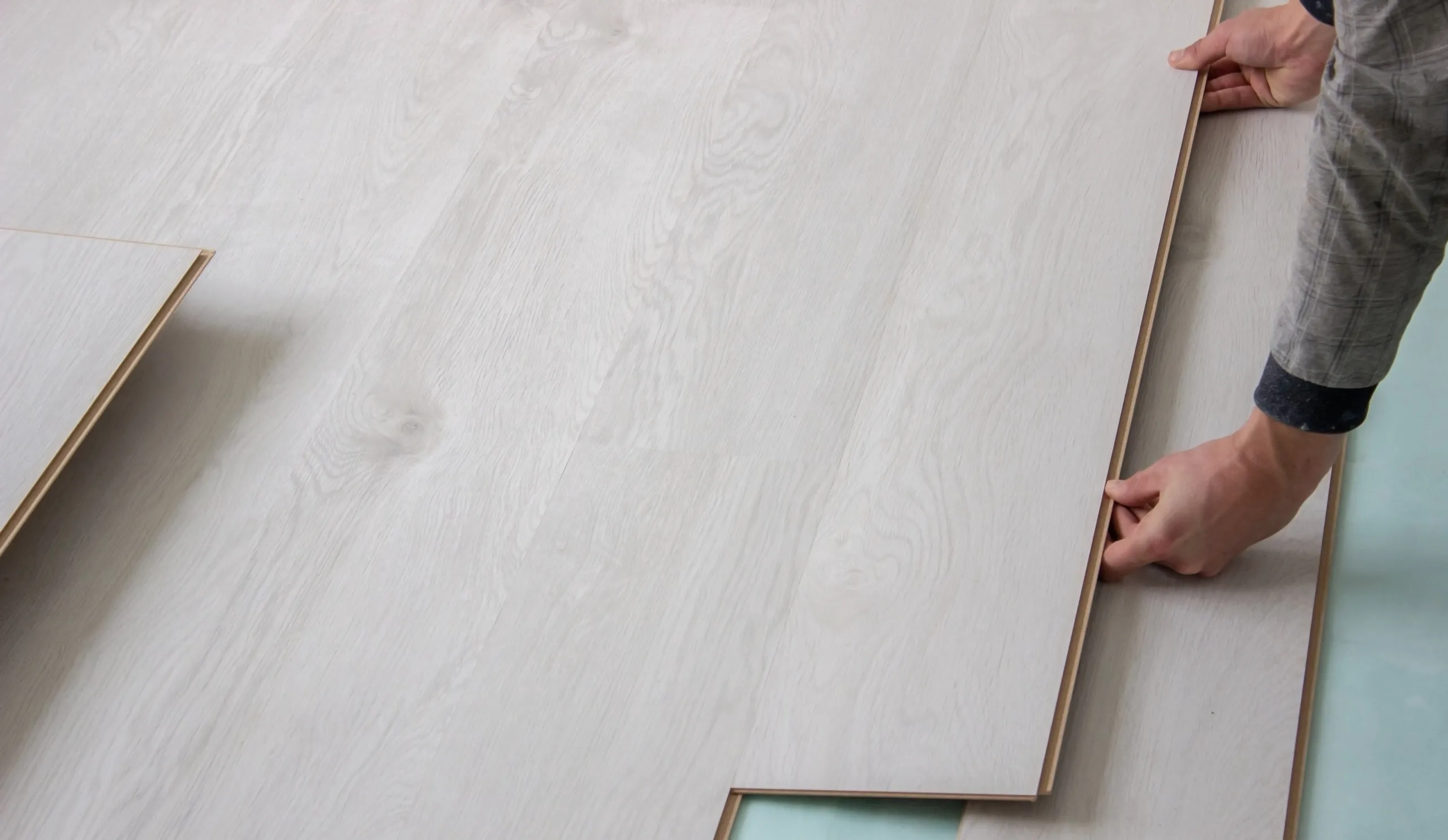 Installing laminate flooring with precision and care by skilled hands