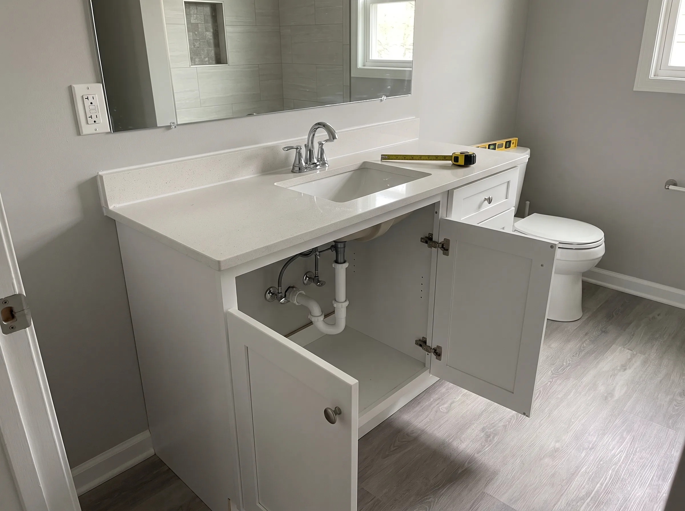 Modern bathroom vanity installation with a white cabinet and sink